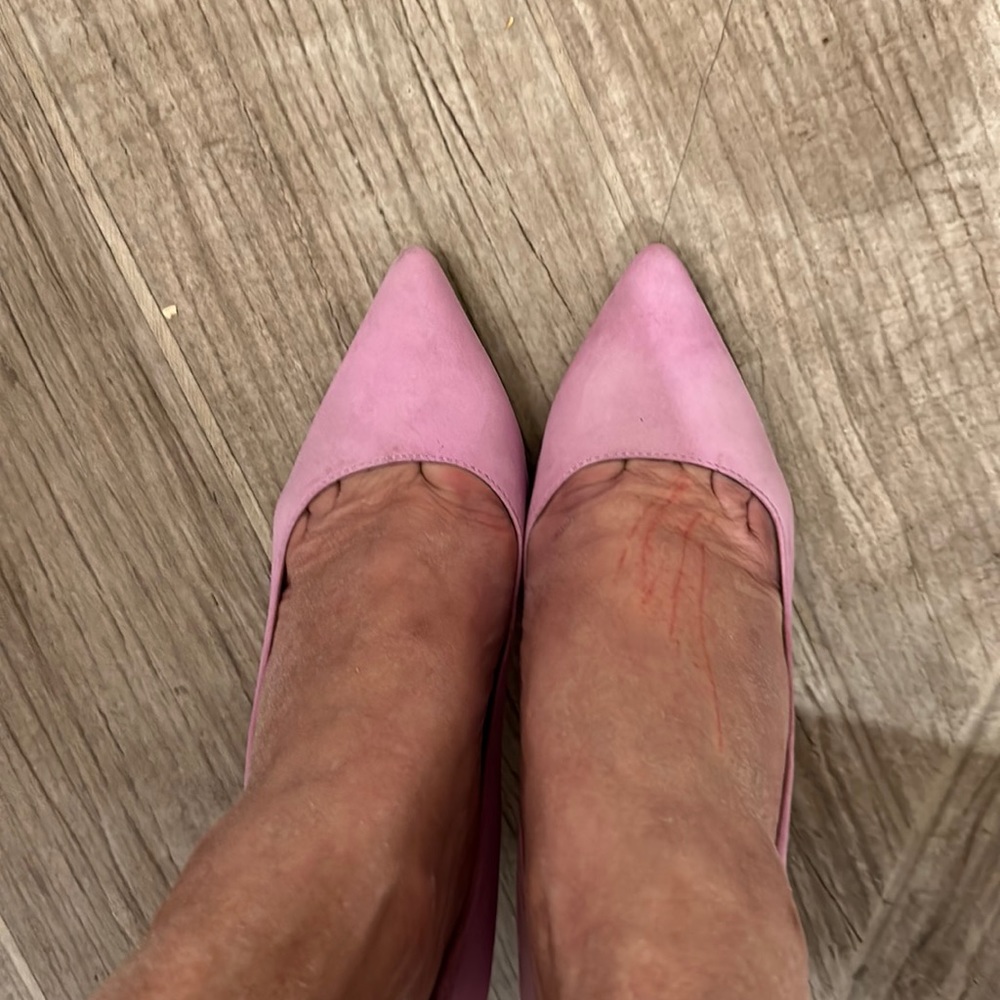 A pair of lovely pastel lilac stiletto heel court shoes .